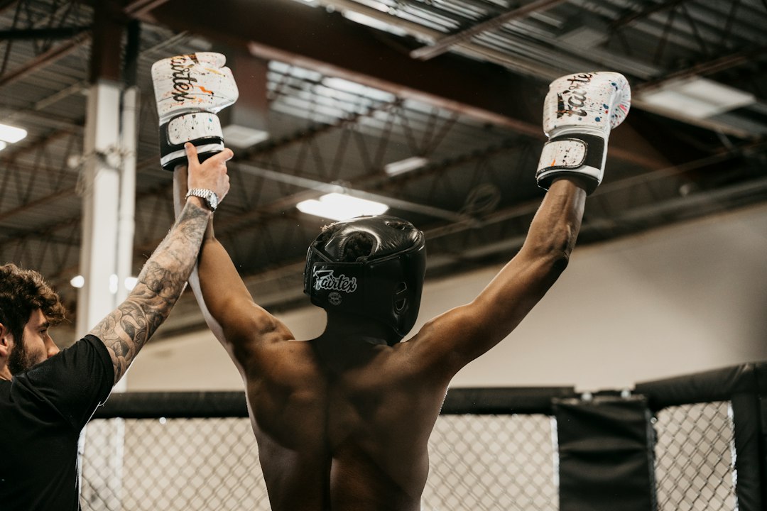 a couple of men standing next to each other in a gym