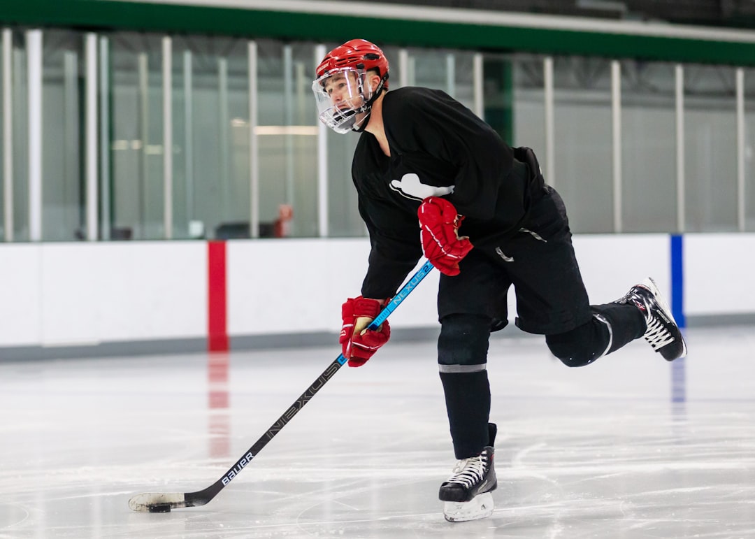 a person on a ice rink with a hockey stick