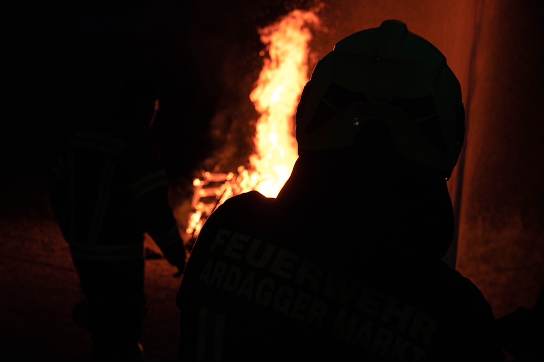 a person standing in front of a fire